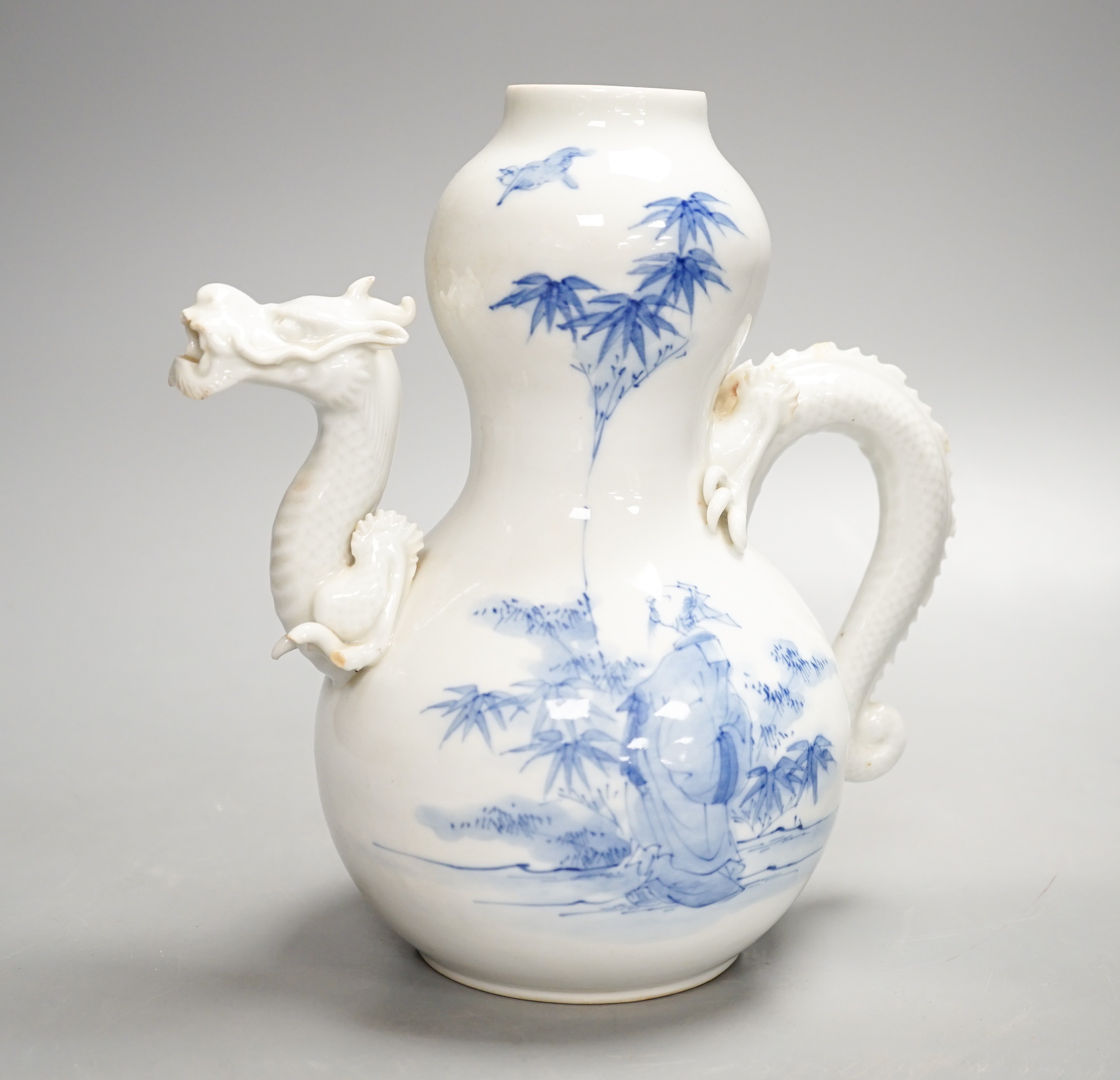 A Japanese Hirado blue and white 'dragon' wine pot, late 19th century, of double gourd shape, (losses) 19.5cm